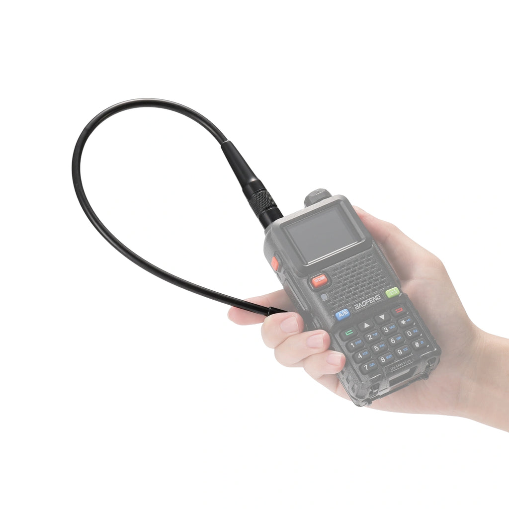 Hand holding a handheld electronic device with a V100C Airband & 1.25M Antenna on a white background