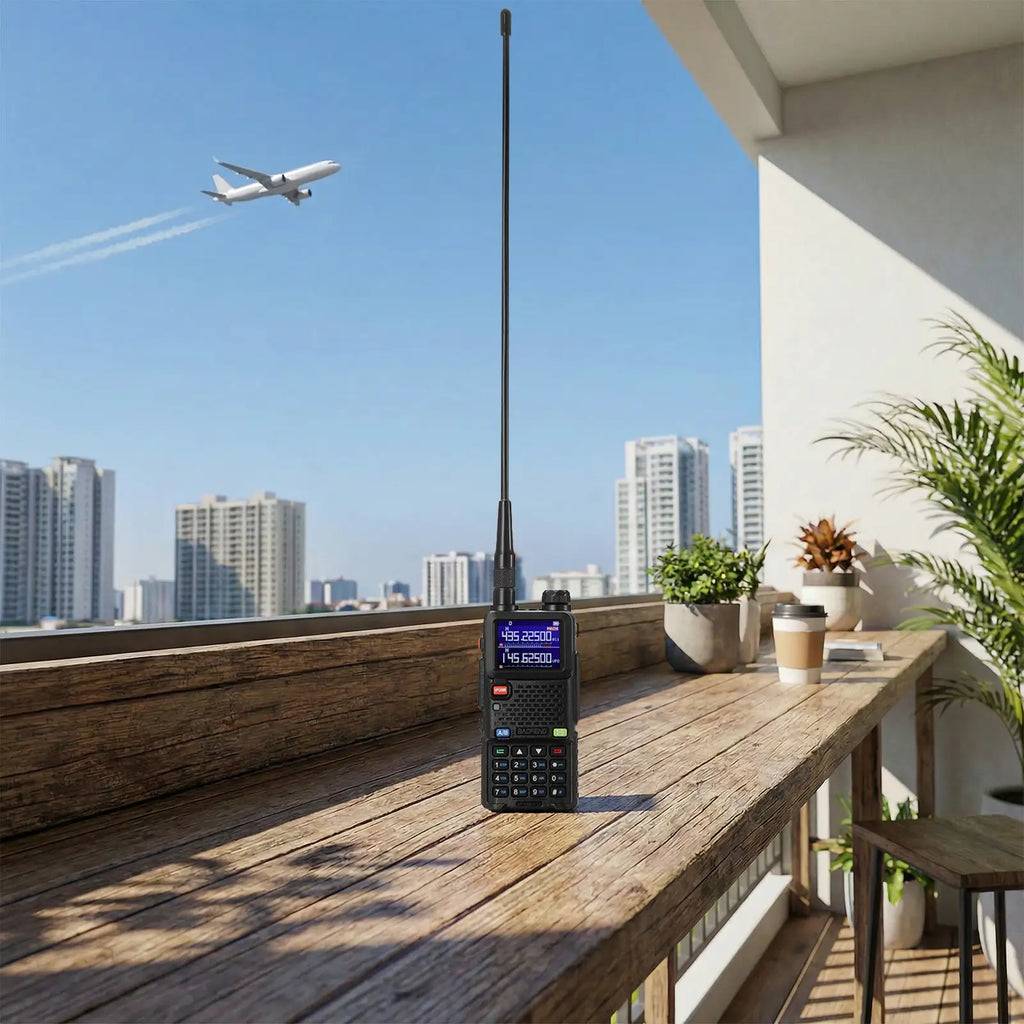 Black walkie-talkie on a wooden table with a cityscape and airplane in the background