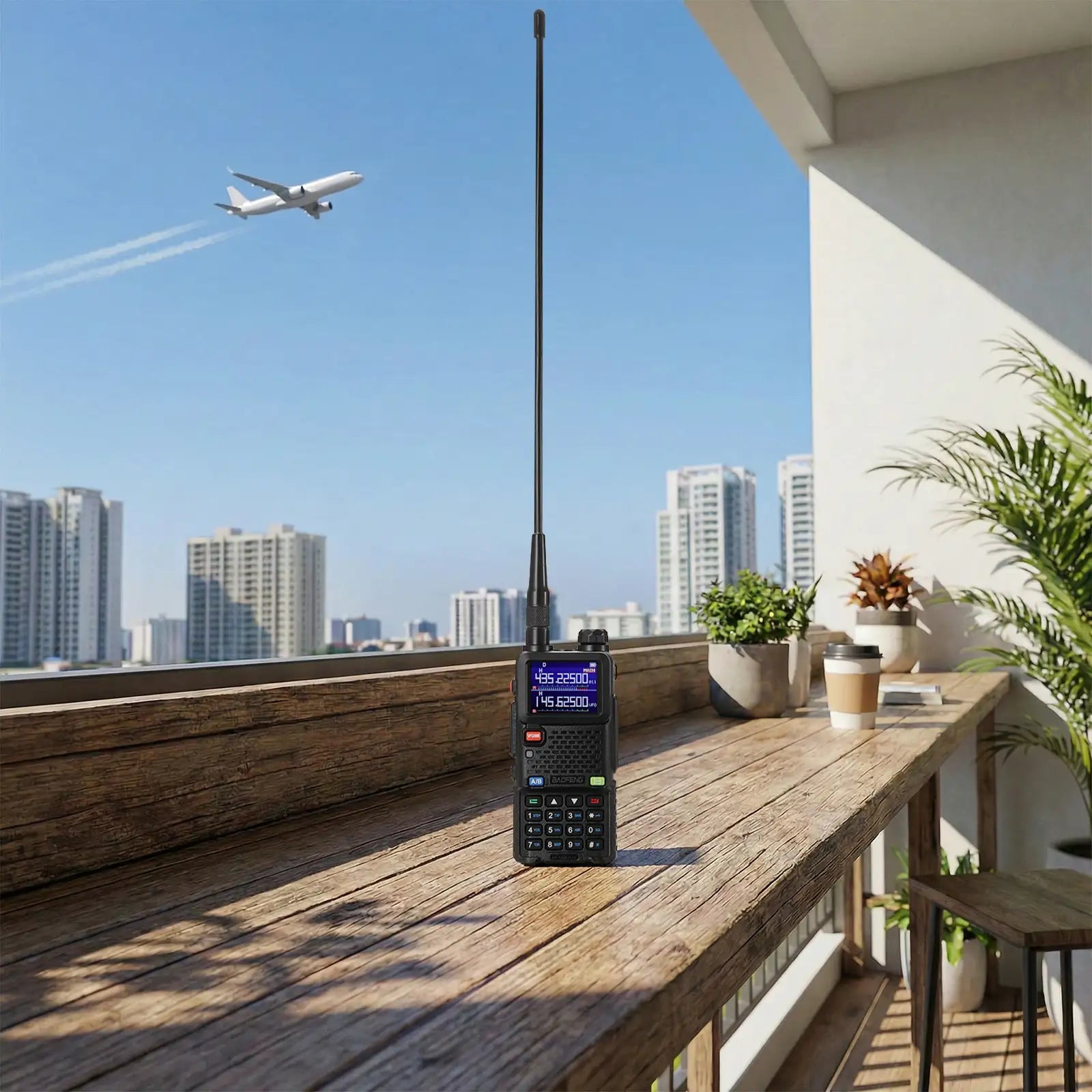 Black walkie-talkie on a wooden table with a cityscape and airplane in the background