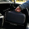 Black PB5 Walkie Talkie Carrying Case with dimensions being held by a person inside a car.