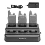 Four Baofeng walkie talkies on a charging station with a power adapter.